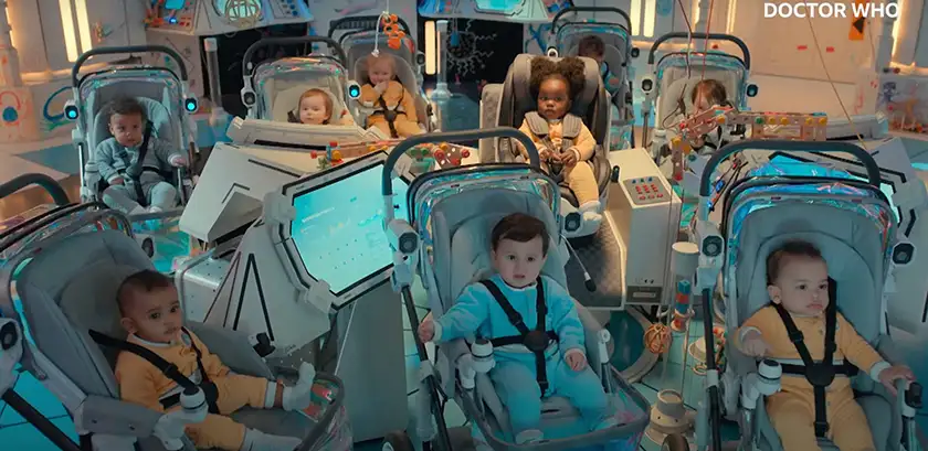 Babies sit in strollers surrounded by a futuristic setting and looking ahead in the Season 1 Premiere of Doctor Who (2024)